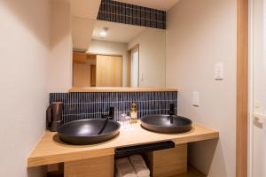 a bathroom with two sinks on a counter at Rinn Niomon in Kyoto