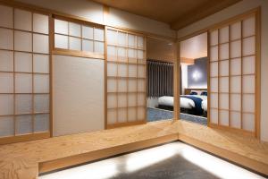 a japanese room with a view of a bedroom at Rinn Niomon in Kyoto