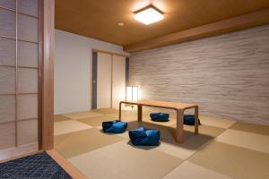 a room with a table and some blue cushions at Rinn Niomon in Kyoto +28 photos