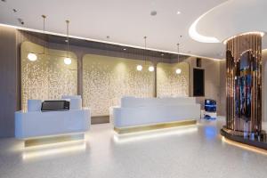 a lobby of a store with white furniture and lights at Xinhuating Business Hotel in Lishui