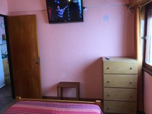a bedroom with a bed and a dresser and a mirror at Hernandarias 2 in San Bernardo