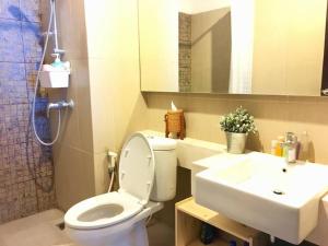 a bathroom with a toilet and a sink at Strategic Cozy Hang Out Apartment, GP Plaza in Jakarta