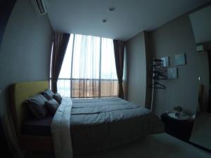 a bedroom with a bed and a large window at Strategic Cozy Hang Out Apartment, GP Plaza in Jakarta