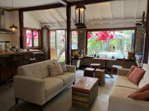 a living room with two couches and a table at Pouso Jardim de Assis in Ouro Preto