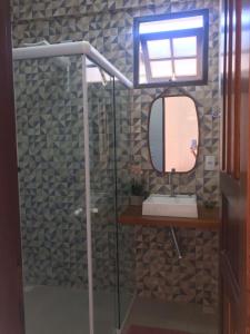 a bathroom with a shower with a mirror and a sink at Herdeiros do Pai in Paraty +19 photos