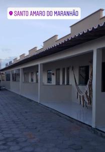 a building with a sidewalk in front of it at Dunas Residence - Casa 06 in Santo Amaro