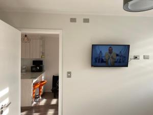 a television hanging on a wall in a kitchen at departamento excelente ubicacion in Puerto Montt