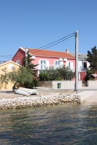 a house on the shore of a body of water at Twin Room Kustici 6288a in Kustići