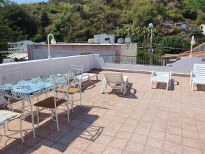 a patio with a table and chairs on a roof at Case Vacanza Armando "Lipari" in Canneto