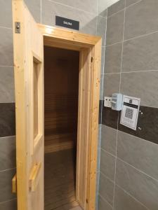 a wooden door in a room in a bathroom at Nur Mateen's Studio - Vista Bangi Service Apartment in Kajang