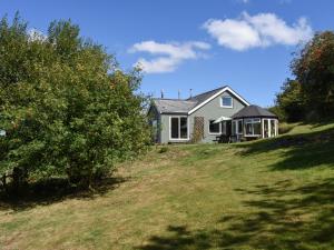 a house sitting on top of a grassy hill at Kestorway in Gidleigh