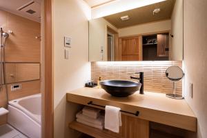 a bathroom with a black bowl sink on a counter at Rinn Tsukinowa West in Kyoto