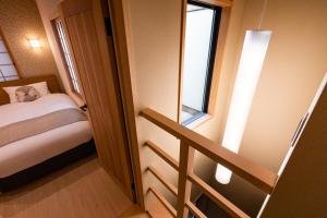 a small room with a bed and a window at Rinn Tsukinowa West in Kyoto