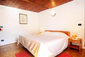 a bedroom with a white bed and a wooden ceiling at Apartment Groznjan 7038a in Grožnjan