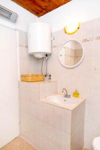 a bathroom with a sink and a mirror at Apartment Groznjan 7038a in Grožnjan