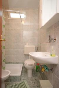 a bathroom with a toilet and a sink at Apartments with a parking space Porec - 7024 in Poreč
