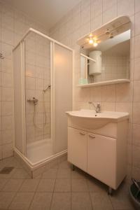 a bathroom with a shower and a sink and a shower at Apartments with a parking space Novigrad - 7017 in Novigrad Istria
