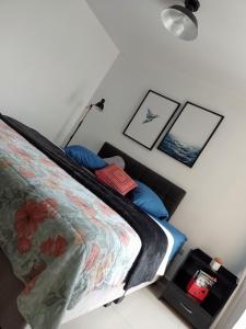 1 dormitorio con 1 cama con almohadas azules en A minutos del centro Con cochera, en Trujillo