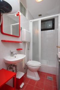 a bathroom with a white toilet and a sink at Apartments with a parking space Zambratija, Umag - 7059 in Zambratija