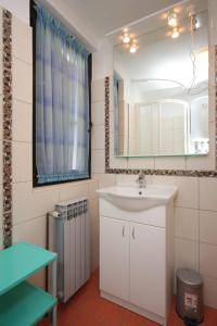 a bathroom with a sink and a mirror at Apartments with a parking space Zambratija, Umag - 7059 in Zambratija