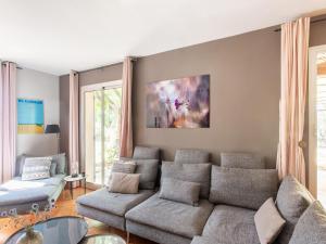 a living room with a couch and a table at Very attractive detached villa with its own swimming pool in Aups