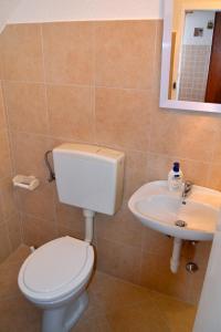 a bathroom with a toilet and a sink at Apartments by the sea Zambratija, Umag - 7030 in Zambratija