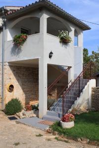 a house with stairs and flower boxes on it at Apartments with a parking space Tar, Porec - 7026 in Tar