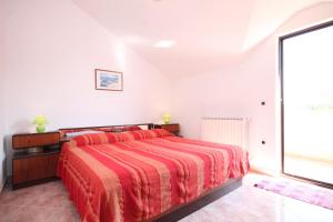 a bedroom with a bed and a large window at Apartments by the sea Zambratija, Umag - 6997 in Zambratija
