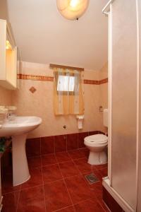 a bathroom with a toilet and a sink at Apartments by the sea Zambratija, Umag - 6997 in Zambratija