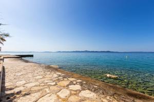 - une vue sur une étendue d'eau avec une jetée dans l'établissement Apartments by the sea Kozino, Zadar - 5755, à Petrčane