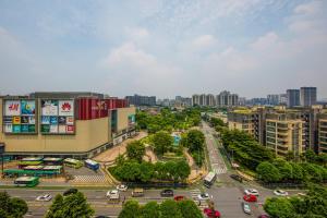 Foshan Yumi Apartment Bodun Branch في فوشان: اطلالة جوية على مدينة فيها سيارات على شارع