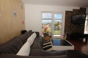 a living room with a couch and a tv at Apartments with WiFi Cavtat, Dubrovnik - 9063 in Cavtat