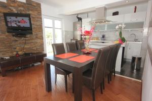 a kitchen and dining room with a table and chairs at Apartments with WiFi Cavtat, Dubrovnik - 9063 in Cavtat +11 photos