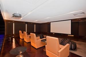a conference room with chairs and a projection screen at Oracle Resort - Q Stay in Gold Coast