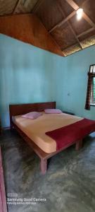 a bedroom with a large bed in a room at Lawang Inn in Bukit Lawang