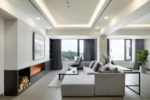 a living room with a couch and a fireplace at Flower Garden Hotel in Hanoi