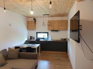 a living room and kitchen with a couch and a table at Domek u Antosia in Mechelinki