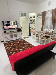a living room with a bed and a dining room at AW City House Yogyakarta in Yogyakarta
