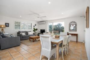 a dining room and living room with a table and chairs at Summer Salt in Byron Bay