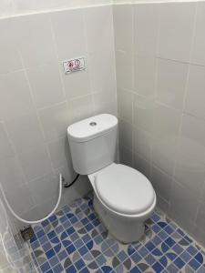 a bathroom with a white toilet in a room at AW City House Yogyakarta in Yogyakarta +10 photos