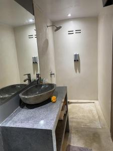 a bathroom with a large sink and a mirror at The Palms Canggu in Canggu