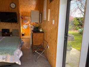 a bedroom with a bed and a desk and a window at Glenwai in Motueka