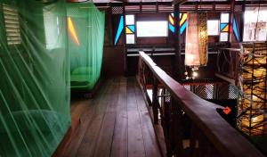 a room with stained glass windows and a wooden floor at The Kasbah Langkawi in Pantai Cenang