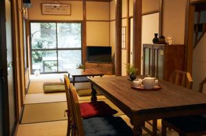 a living room with a wooden table and a dining room at Kagurazaka Retro BAR & HOTEL in Tokyo