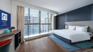 a hotel room with a bed and a large window at Holiday Inn Express Chengdu High-Tech Zone in Chengdu