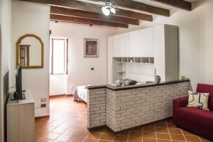 a living room with a red couch and a brick wall at Casa Vacanze da Angela in Alghero
