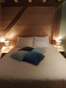a bed with two pillows on it with two lamps at Chalet Lisa in Morzine