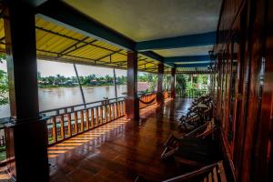a house with a view of a river from a balcony at Bontai Resort, Don Khon in Ban Khon