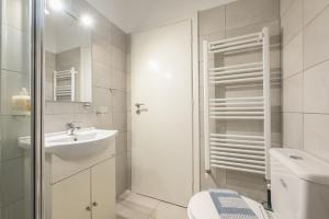 uma casa de banho branca com um WC e um lavatório em The Boutique Studio by CloudKeys em Atenas