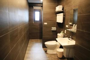 a bathroom with a toilet and a sink at H Suite Sea in Lukang